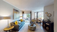 Located at 1921 New Garden Rd in Greensboro, NC, this single-floor residence offers a thoughtfully designed layout with a welcoming, cohesive aesthetic throughout. The open living and dining area is bright and inviting, featuring wood-style flooring, crown molding, and large windows and a sliding glass door that flood the space with natural light and provide views of the surrounding greenery. A private balcony extends from the living area, offering an outdoor retreat.

The kitchen is well-equipped with granite countertops, white cabinetry, a subway tile backsplash, and stainless steel appliances, including a range with a ventilation hood. A casual dining nook situated adjacent to the kitchen benefits from additional window views of the outdoors.

The bedrooms are carpeted and generously sized, with ample natural light. One bedroom features a bold accent wall that adds visual character to the space. The bathrooms are clean and functional, with one offering a full tub-shower combination, granite vanity countertops, and wood-style flooring. A second bathroom provides convenient access from the common areas.

Completing the unit is a dedicated in-unit laundry area with full-size washer and dryer hookups and built-in shelving for added storage. The overall ambiance is warm and comfortable, with consistent finishes tying each room together seamlessly.