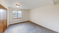 Located at 3120 Staten Ave in Lansing, MI, this one-bedroom, one-bathroom unit offers a well-organized single-floor layout designed for efficient, comfortable living. The combined dining and living area provides an open, versatile space with soft carpeted flooring, a textured ceiling, and a wall-mounted air conditioning unit, creating a welcoming atmosphere throughout. A baseboard heating system runs along the perimeter, ensuring year-round comfort. The galley-style kitchen features warm oak cabinetry on both walls, a double stainless steel sink, light-toned countertops, tile flooring, and white appliances including a coil-top range and full-size refrigerator — all within a practical, efficient layout. The bedroom is a generously sized, carpeted retreat with a large window that invites natural light and outdoor views, complemented by baseboard heating and a textured ceiling. The bathroom includes a single-sink oak vanity with storage, a wide mirror with a multi-bulb light fixture, tile flooring, and a full toilet, all finished in neutral tones. The unit also includes four closets offering abundant storage, a dedicated entrance, a connecting hallway, and access to a private balcony — a welcome outdoor extension of the living space.