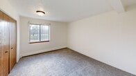 Located at 3120 Staten Ave in Lansing, MI, this one-bedroom, one-bathroom unit offers a well-organized single-floor layout designed for efficient, comfortable living. The combined dining and living area provides an open, versatile space with soft carpeted flooring, a textured ceiling, and a wall-mounted air conditioning unit, creating a welcoming atmosphere throughout. A baseboard heating system runs along the perimeter, ensuring year-round comfort. The galley-style kitchen features warm oak cabinetry on both walls, a double stainless steel sink, light-toned countertops, tile flooring, and white appliances including a coil-top range and full-size refrigerator — all within a practical, efficient layout. The bedroom is a generously sized, carpeted retreat with a large window that invites natural light and outdoor views, complemented by baseboard heating and a textured ceiling. The bathroom includes a single-sink oak vanity with storage, a wide mirror with a multi-bulb light fixture, tile flooring, and a full toilet, all finished in neutral tones. The unit also includes four closets offering abundant storage, a dedicated entrance, a connecting hallway, and access to a private balcony — a welcome outdoor extension of the living space.