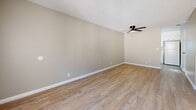 Located at 345 W 41st St in San Bernardino, CA, this single-story 2-bedroom, 1-bathroom home offers a practical and comfortable layout with consistent design choices throughout. Light wood-style flooring runs seamlessly across the entire home, complemented by neutral beige walls and crisp white baseboards that create a clean, cohesive aesthetic.

The combined living and dining area is an open, versatile space featuring a ceiling fan and a large front-facing window that draws in natural light and views of the outdoors. A textured ceiling adds dimension to the room throughout the home.

The galley-style kitchen is efficiently designed with ample white cabinetry, light stone-look countertops, a gas range, a double-basin sink, and a window that keeps the space bright and airy.

Both bedrooms are well-proportioned and share a similar neutral palette. The primary bedroom features mirrored sliding closet doors that enhance the sense of space. The second bedroom includes a window with vertical blinds, providing natural light and privacy. Each bedroom benefits from multiple closets, with five closets total throughout the home.

The full bathroom is neatly appointed with a white vanity featuring stone-look countertops, a black matte faucet, a tub-shower combination with tile surround, and a natural light window. A central hallway connects all rooms efficiently.
