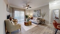 Located in Johns Creek, GA, this well-appointed 2-bedroom, 2-bathroom single-floor residence offers a comfortable and functional layout. The living room serves as the heart of the home, featuring hardwood-style flooring, crown molding, a ceiling fan, and sliding glass doors that flood the space with natural light and provide direct access to an outdoor patio. Adjacent to the living room, the dining area is defined by elegant crown molding and a contemporary chandelier overhead, creating an inviting space for meals. The galley-style kitchen is equipped with stainless steel appliances, including a gas range and refrigerator, white shaker cabinetry, a subway tile backsplash, and light countertops — offering both style and efficiency. The primary bedroom features plush carpeting and connects to a spacious walk-in closet with wire shelving. The second bedroom is bright, with a large window and its own closet access. Both bathrooms are clean and well-finished with shower/tub combinations. A dedicated in-unit laundry room adds everyday convenience. Neutral warm tones throughout create a cohesive, calming ambiance across all rooms.