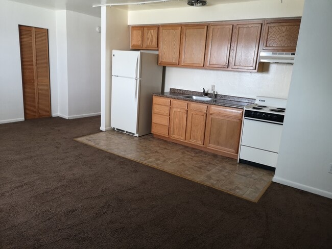 KItchen Area Beige Refrigerator and Range - 120 S Negley Ave