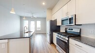 Located in Austin, TX (78717), this thoughtfully designed one-bedroom, one-bathroom residence offers a functional and modern living experience. The open-concept kitchen is a standout feature, showcasing white shaker cabinetry, dark granite countertops, a central island with additional seating space, and a full suite of stainless steel appliances including a gas range, built-in microwave, and refrigerator. A tile backsplash and pendant lighting complete the polished look. Wood-style luxury vinyl plank flooring runs throughout the main living areas, adding warmth and continuity to the space. The living area benefits from natural light through a glass door and flanking windows, and is outfitted with a ceiling fan overhead. The bedroom features plush carpet, a large window with outdoor views, and direct access to the bathroom. The bathroom includes white cabinetry with granite countertops and tile flooring, and connects to a dedicated walk-in closet with built-in shelving and hanging rods. A dedicated entrance and additional closet storage round out the practical elements of this well-appointed Austin residence.