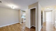 Located at 2400 Cluette Dr in Raleigh, NC, this single-floor, 3-bedroom, 2-bathroom residence offers a practical and comfortable layout with a warm, neutral color palette throughout. The living area features gleaming wood-style flooring and is bathed in natural light from large windows and a glass-paned door that opens to a private balcony overlooking a serene, tree-lined setting. The kitchen is efficiently designed in a U-shape, outfitted with light wood cabinetry, white appliances including a range, dishwasher, and refrigerator, and is finished with matching wood-style floors. The spacious primary bedroom features plush carpeting, a ceiling fan, and the convenience of two closets, complemented by an en-suite bathroom with a single vanity and tub-shower combination. A walk-in closet with wire shelving provides generous storage. The second bathroom mirrors a similar functional design. Bedrooms are connected via a carpeted hallway, offering clear separation between living and sleeping areas. Textured ceilings and clean white trim are consistent throughout, contributing to a cohesive, well-maintained aesthetic. The balcony delivers peaceful outdoor views of mature trees, adding a touch of nature to this Raleigh residence.