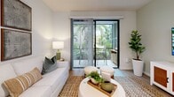 Located in Wellington, FL, this thoughtfully designed two-bedroom, two-bathroom residence offers a bright, modern living experience across a single floor. The open-concept kitchen and living area serves as the heart of the home, featuring sleek white flat-panel cabinetry extending to the ceiling, stainless steel appliances, a crisp white quartz island with bar seating, and elegant pendant lighting. Light wood-look flooring flows seamlessly throughout, enhancing the airy, cohesive aesthetic. The living area opens directly to a private patio through sliding glass doors, offering lush greenery views and filling the space with natural light. The generously sized primary bedroom includes a ceiling fan, large windows overlooking greenery, and ample closet space. The second bedroom mirrors this comfortable, light-filled quality. Both bathrooms are finished in clean white tile; one features a wood-toned vanity with a white quartz countertop and a walk-in shower, while the other includes a tub-shower combination. A dedicated in-unit laundry room with side-by-side washer and dryer adds everyday convenience. Four closets provide exceptional storage throughout. The overall ambiance is clean, contemporary, and inviting — ideal for comfortable Florida living.