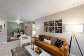 Located at 15685 Goddard Rd in Southgate, Michigan, this single-floor, two-bedroom, two-bathroom home offers a well-designed layout with a comfortable and functional living experience. The open-concept living room flows seamlessly into the dining area, featuring neutral-toned walls, plush carpeting, and large windows that invite natural light. A distinctive green accent wall in the dining area adds a touch of character to the shared space.

The kitchen is outfitted with white shaker cabinetry, marble-style countertops, stainless steel appliances, and hardwood-style flooring, balancing style with practicality. A dedicated utility room with in-unit laundry adds everyday convenience.

The spacious primary bedroom features dual windows with outdoor views, soft carpeting, and neutral walls, creating a calm and restful retreat. The second bedroom is equally well-appointed with natural light. Both bathrooms are finished with white tile flooring, white cabinetry, marble-style countertops, and tub/shower combinations, offering a clean, classic aesthetic.

Three closets throughout the home provide generous storage. The entrance leads directly into the main living area, and a hallway connects the bedrooms and bathrooms, creating a logical and efficient floor plan throughout.