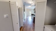Located at 970 Riverside Forest Way in Knoxville, Tennessee, this single-floor residence offers three bedrooms and three bathrooms within a well-designed, functional layout. The open kitchen and living area serve as the heart of the home, where warm hardwood-style flooring flows throughout. The kitchen is appointed with rich dark-wood cabinetry, dark granite countertops, a classic subway tile backsplash, and a full suite of stainless steel appliances including a range, microwave, dishwasher, and refrigerator. Track lighting illuminates the space, while large windows allow natural light to fill the living room, which also features a ceiling fan and direct access to a private balcony with leafy outdoor views. The three bedrooms are carpeted for comfort, with neutral tones and ample natural light. Each bedroom benefits from its own dedicated bathroom, with tub/shower combinations and clean, functional finishes. Three closets provide generous storage throughout. A central hallway connects the private bedroom wing to the main living areas, contributing to an efficient and organized floor plan. The overall aesthetic is clean and contemporary, with a neutral color palette that creates a bright, welcoming atmosphere throughout.