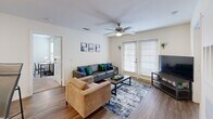 Located at 2400 N Morrison Blvd in Hammond, Louisiana, this well-appointed 2-bedroom, 2-bathroom unit offers a thoughtfully designed single-floor layout. A welcoming entry hallway, accented with wall art, leads into the heart of the home where wood-style flooring flows throughout the main living areas. The galley-style kitchen is equipped with light wood cabinetry, granite-look countertops, black appliances including a range, dishwasher, and refrigerator, and features a peninsula with bar seating that opens toward the living area. The living room is bright and comfortable, highlighted by a ceiling fan, a sliding glass patio door that invites natural light, and direct outdoor access. Both bedrooms are carpeted and include ceiling fans and windows. The primary bedroom features mirrored sliding closet doors, while the second bedroom offers a cozy layout with natural light. Each bathroom is finished with wood-style flooring, granite-look countertops, and warm wood cabinetry. The primary bath includes a full tub-shower combination, while the secondary bath features a vanity with bold yellow cabinetry. A utility room completes the floor plan, adding practical storage and laundry functionality to this efficient and comfortable residence.