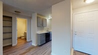 Located at 121-221 East Wedgewood in Spokane, WA, Unit L202 is a thoughtfully designed single-floor residence that combines functional living spaces with practical finishes throughout. The open living area features durable wood-look flooring, a textured ceiling, a wall-mounted air conditioning unit, and a baseboard heating system. A sliding glass door leads to a private balcony, filling the room with natural light and offering pleasant outdoor views.

The galley-style kitchen is efficiently laid out with gray cabinetry, light countertops, a single-basin sink, and black appliances including a range, over-the-range microwave, refrigerator, and dishwasher. Wood-look flooring continues through the kitchen, and a window at the end of the galley brings in additional natural light.

The bedrooms are carpeted for comfort, each featuring windows that invite natural light and baseboard heating for year-round comfort. The layout provides a quiet, restful atmosphere in each sleeping area.

The bathroom is clean and functional, featuring gray vanity cabinetry with light countertops, a bathtub, and wood-look flooring that ties the space together with the rest of the unit. The consistent use of neutral tones and updated finishes throughout the residence creates a cohesive and welcoming atmosphere.