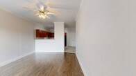 Located at 5950 Antoine Dr in Houston, TX, this single-story, 2-bedroom, 2-bathroom home offers a practical and well-appointed layout. The open living area features warm hardwood-style flooring, neutral-toned walls, and crown molding that adds a refined architectural detail throughout the space. A pass-through opening connects the living room to the kitchen, creating a sense of openness between the two areas.

The kitchen is equipped with rich, dark cherry wood cabinetry, granite countertops, and black appliances including a gas range, dishwasher, and refrigerator. Light ceramic tile floors and track lighting complete the functional cooking space.

Both bedrooms feature hardwood-style flooring, crown molding, ceiling fans, and windows fitted with horizontal blinds that allow for natural light and outdoor views. The primary bedroom connects to its own bathroom, providing added privacy and convenience.

Each bathroom is finished with light ceramic tile floors, cherry wood vanities topped with granite countertops, mirrored storage, and clean white fixtures. One bathroom includes a full bathtub and shower combination. A hallway and dedicated closet space round out the floor plan, contributing to the home's efficient and comfortable use of space throughout.