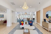 Located at 302 Cabana Blvd in Panama City Beach, Florida, this single-floor residence offers a thoughtfully designed open-concept layout with a warm coastal aesthetic throughout. The kitchen is a standout feature, appointed with rich cherry wood cabinetry, dark granite countertops, stainless steel appliances including a dishwasher and refrigerator, and a peninsula with a double basin sink. Elegant pendant lighting illuminates the workspace, while a pass-through opening connects the kitchen seamlessly to the living and dining areas. The living room is bright and airy, benefiting from abundant natural light through French doors that open to the outdoors, complemented by a ceiling fan overhead and durable wood-look flooring that runs throughout the home. The bedrooms are comfortably sized, each featuring ceiling fans, large windows that invite natural light, and generous closet space — including a spacious walk-in closet. The bathrooms mirror the kitchen's design language with matching cherry cabinetry and granite countertops, paired with a full tub and shower. A dedicated laundry room houses a full-size washer and dryer. The overall ambiance is light, clean, and coastal — well-suited to the Panama City Beach setting.