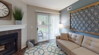 Located at 1555 Saddle Brook Lane in Westlake, Ohio, this single-floor residence offers a well-appointed layout with a cohesive, contemporary aesthetic throughout. The living area serves as a welcoming central space, featuring wood-look flooring, a sliding glass door that opens to an outdoor patio with greenery views, and a distinctive accent wall in muted blue-grey that adds depth and character. A decorative geometric wall piece and tufted sofa contribute to the room's polished, modern feel.

The galley-style kitchen is efficiently designed with rich dark cabinetry, light marble-look countertops, subway tile backsplash, and stainless steel appliances. A hallway connects the kitchen to additional utility areas, enhancing the functional flow of the space.

The bedrooms are carpeted and well-lit, each receiving natural light through blinded windows. Textured ceilings and neutral wall tones create a calm, restful atmosphere, while thoughtful décor details such as wood-framed headboards and layered bedding add warmth. One bedroom includes access to a walk-in closet.

The bathroom is finished with wood-look flooring, dark wood vanity cabinetry, a white countertop, and a large mirror, giving it a clean and contemporary look. Overall, the residence presents a comfortable and cohesive living environment.