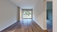 Located at 95 Generation Blvd in Toronto's Scarborough community, this 1-bedroom, 1-bathroom unit offers a thoughtfully designed single-floor layout with a clean, modern aesthetic throughout. Warm hardwood-style flooring flows continuously across the living areas, hallways, and bedroom, creating a cohesive and inviting atmosphere.

The living room is a standout space, featuring large sliding glass doors that frame lush, tree-lined outdoor views and flood the room with natural light. The kitchen is well-equipped with white cabinetry, subway tile backsplash, stone-finish countertops, and stainless steel appliances, complemented by a skylight-style overhead fixture that brightens the workspace.

The bedroom offers a comfortable footprint with a large sliding-door closet providing ample storage, a window with views of the surrounding neighbourhood, and a baseboard heating unit. The bathroom features a full soaking tub with clean white ribbed wall surrounds and polished chrome fixtures.

Neutral grey and white tones throughout the unit lend a fresh, move-in-ready feel, while multiple hallways connect the rooms efficiently. The layout is practical and makes strong use of the available space, making this unit an informative example of functional urban residential design.