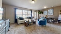 This single-floor residence offers a thoughtfully designed layout that balances comfort and functionality throughout its key living spaces. The kitchen is a standout feature, equipped with dark espresso cabinetry, granite-style countertops, stainless steel appliances including a refrigerator with an ice and water dispenser, electric range, built-in microwave, and dishwasher. Large floor tiles add a clean, polished finish, while a breakfast bar provides a casual dining option. The open living area is generously sized, featuring plush wall-to-wall carpeting, large windows dressed with blinds and curtain panels that invite abundant natural light, and a warm, welcoming ambiance ideal for relaxing or entertaining. The bedrooms continue the carpeted flooring and offer ample space, natural light through sizable windows, and practical storage including closets. The primary bedroom is notably spacious and includes a ceiling fan with light fixture. The bathrooms are finished with large-format floor tiles, dark cabinetry, and full tub/shower combinations with tiled surrounds. Throughout the unit, neutral wall tones and consistent finishes create a cohesive, comfortable living environment.
