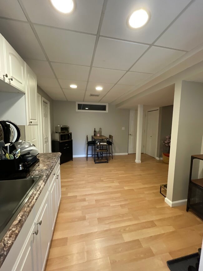 The kitchen leads into the dining area and bathroom to the left. - 18 Old Neck Ct