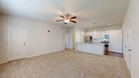Located at 1305 S Heritage Pkwy in Sherman, TX, this one-bedroom, one-bathroom residence offers a well-designed, efficient layout across a single floor. The open-concept living and kitchen area serves as the heart of the home, featuring plush carpeting in the living space and durable wood-look flooring in the kitchen. A ceiling fan with light fixture keeps the living area comfortable, while two windows allow natural light to brighten the space.

The kitchen is a standout, showcasing granite countertops, a peninsula island with a stainless steel sink, white cabinetry, a subway tile backsplash, and a full suite of stainless steel appliances including a refrigerator, range, and over-the-range microwave. Pendant lighting adds a stylish finishing touch above the island.

The bedroom is a comfortable retreat with its own ceiling fan, carpeted flooring, and two windows that bring in natural light. It is complemented by a spacious walk-in closet equipped with wire shelving for ample storage. The bathroom features wood-look flooring, a granite-topped vanity with white cabinetry, and a bathtub/shower combination. A dedicated laundry area accommodates a full-size washer and dryer, complete with overhead wire shelving for additional storage.