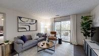 Located at 1300 Beaver Ruin Rd in Norcross, Georgia, this single-floor residence offers a thoughtfully designed open-concept layout that seamlessly connects the kitchen, dining, and living areas. The kitchen features white cabinetry, stainless steel appliances including a refrigerator and microwave, and a peninsula with bar seating — ideal for casual dining or entertaining. Adjacent to the kitchen, the dedicated dining area is defined by wood-look flooring, chair-rail wall detailing, and recessed lighting overhead. The living room is a bright and inviting space, highlighted by a sliding glass door that opens to a private balcony with views of surrounding greenery, filling the room with natural light. The bedroom offers a comfortable retreat with a ceiling fan, wood-look flooring, and a window framing outdoor views. The bathroom is finished with white cabinetry, a single vanity with a large mirror, and brushed nickel hardware. A dedicated in-unit laundry area provides added convenience. Throughout, the space maintains a clean, neutral palette with consistent wood-look flooring, creating a cohesive and modern aesthetic well-suited to everyday living in the Norcross area.
