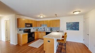 Located in Sylvania, Ohio, this 2-bedroom, 3-bathroom residence offers a thoughtfully designed single-floor layout that maximizes both function and comfort. The open-concept kitchen and living area forms the heart of the home, where warm honey-toned cabinetry, granite countertops, and a mosaic tile backsplash create a polished aesthetic. A peninsula with bar seating provides additional dining space, while black appliances and ample upper and lower cabinet storage add practicality. Rich hardwood flooring flows throughout the main living areas, anchoring the space with warmth.

The living room is bright and inviting, benefiting from a large sliding glass door that fills the room with natural light and provides outdoor access. The primary bedroom offers a comfortable, well-proportioned retreat with carpeted flooring, natural light from a window, and wall-mounted lighting fixtures. A versatile second bedroom features hardwood floors and a large window, making it equally suited as a home office or guest room.

Three bathrooms are finished consistently with granite-topped vanities, warm wood cabinetry, and tile flooring, contributing to a cohesive design throughout. A dedicated closet provides additional storage. Clean lines, neutral tones, and consistent finishes across every room create a unified, move-in-ready living environment.