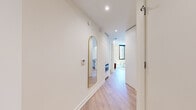 Located in Washington, DC's vibrant Union Market neighborhood, this modern 2-bedroom, 2-bathroom residence offers a thoughtfully designed single-level layout with clean contemporary aesthetics throughout. Light wood flooring flows seamlessly across the open-plan living and kitchen area, where floor-to-ceiling windows with black frames flood the space with natural light and offer expansive views of the surrounding cityscape. A private balcony is accessible directly from the living area, extending the sense of openness.

The kitchen features flat-front white cabinetry, a glossy tile backsplash, stone countertops, and stainless steel appliances including a gas cooktop and built-in oven — a fully functional and visually cohesive workspace.

Both bedrooms are bright and generously proportioned, with the primary bedroom benefiting from striking floor-to-ceiling windows that frame panoramic views of the Washington, DC skyline. Well-organized closets with built-in shelving and dual hanging rods provide ample storage throughout.

The bathrooms are finished with large-format neutral tiles, floating vanities with undermount sinks, wide mirrors, recessed lighting, and glass-enclosed walk-in showers, delivering a clean and spa-like atmosphere. The overall design is minimal, modern, and move-in ready.