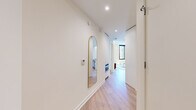 Located in Washington, DC's vibrant Union Market neighborhood, this modern 2-bedroom, 2-bathroom residence offers a thoughtfully designed single-level layout with clean contemporary aesthetics throughout. Light wood flooring flows seamlessly across the open-plan living and kitchen area, where floor-to-ceiling windows with black frames flood the space with natural light and offer expansive views of the surrounding cityscape. A private balcony is accessible directly from the living area, extending the sense of openness.

The kitchen features flat-front white cabinetry, a glossy tile backsplash, stone countertops, and stainless steel appliances including a gas cooktop and built-in oven — a fully functional and visually cohesive workspace.

Both bedrooms are bright and generously proportioned, with the primary bedroom benefiting from striking floor-to-ceiling windows that frame panoramic views of the Washington, DC skyline. Well-organized closets with built-in shelving and dual hanging rods provide ample storage throughout.

The bathrooms are finished with large-format neutral tiles, floating vanities with undermount sinks, wide mirrors, recessed lighting, and glass-enclosed walk-in showers, delivering a clean and spa-like atmosphere. The overall design is minimal, modern, and move-in ready.