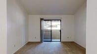 Located at 3200 Truxel Rd in Sacramento, CA, this 2-bedroom, 2-bathroom residence offers a practical and comfortable single-floor layout. The living room is bright and open, featuring plush carpeting and a sliding glass door that fills the space with natural light and provides direct access to a private patio with outdoor views of surrounding greenery. Adjacent to the living area, a dedicated dining space connects seamlessly to the kitchen, which is outfitted with gray cabinetry, laminate countertops, white appliances including a range and refrigerator, and light wood-style flooring. Ample built-in pantry storage adds to the kitchen's functionality. The spacious primary bedroom features soft carpeting and a generous sliding-door closet, while the second bedroom also offers comfortable proportions and its own closet. Three closets throughout the unit provide excellent storage. Both bathrooms are clean and functional — one includes a sliding-door shower enclosure and the other features a vanity with a granite-style countertop and overhead lighting. A hallway connects the bedrooms and bathrooms, and a utility room adds further practicality. The overall ambiance is clean, neutral, and move-in ready.