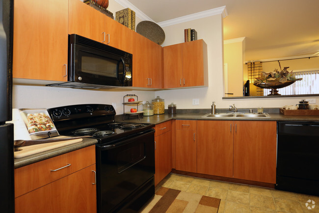 Cherry cabinets w/black GE appliances - Wyngate Apartments