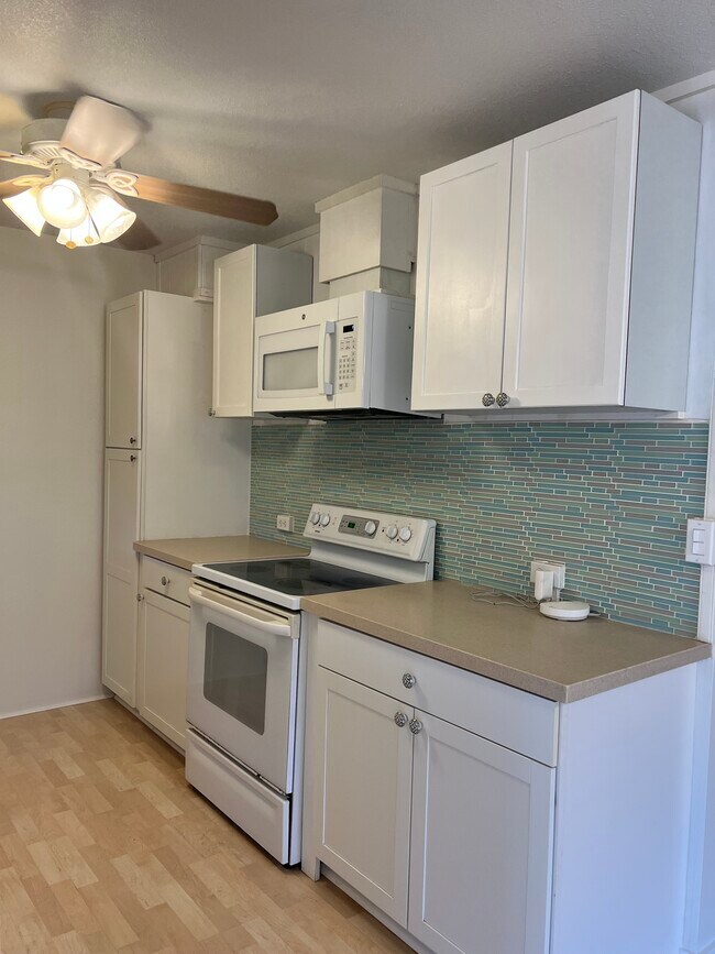 Galley style kitchen. - 66-130 Oliana Pl