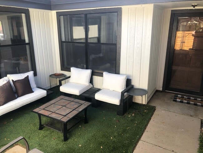 Private patio with lounge seating — perfect for relaxing or working outdoors. - 2401 Thistle Ct