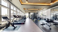 Located at 550 Stanton St in Frederick, MD, this fitness center offers a spacious, single-floor layout designed to support a full range of workout routines. The space is thoughtfully divided into distinct functional zones, including a cardio area lined with treadmills, ellipticals, stair climbers, and rowing machines, and a strength training zone equipped with free weights, cable machines, benches, and multi-functional racks. A dedicated functional training area features TRX suspension systems, resistance bands, and battle ropes, providing versatile training options.

Architecturally, the space stands out with its elegant tray ceilings accented by warm ambient lighting and ceiling fans, adding both style and comfort. Large, floor-to-ceiling windows along multiple walls flood the interior with natural light and offer views of the surrounding neighborhood. The flooring transitions between a herringbone-patterned tile in lighter zones and durable rubber matting in high-impact areas, clearly delineating each section.

A full-length mirror wall with mounted flat-screen TVs anchors the free weights area, while a motivational neon "Your Pace or Mine" sign near the entrance sets an energetic tone. Sleek vertical slat partitions add a modern design element throughout. The overall ambiance is contemporary, bright, and inviting, creating an upscale fitness environment.