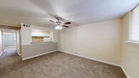 Located at 2206 Heather Ln in Louisville, Kentucky, this single-floor, one-bedroom, one-bathroom unit offers a practical and comfortable layout across a compact but well-organized footprint. The living room is carpeted and open in feel, featuring a ceiling fan with integrated lighting and a pass-through window that connects directly to the kitchen, creating a sense of openness between the two spaces. The kitchen is equipped with white cabinetry, a tile backsplash, and includes a refrigerator, with a countertop bar ledge visible from the living area. The bedroom is a well-proportioned carpeted room with a ceiling fan, a wall-mounted AC unit, and a window fitted with blinds that allows for natural light. The bedroom benefits from generous closet space, including louvered bifold-door closets with built-in shelving and hanging rods. The bathroom is cleanly finished with tile flooring, tile-surround tub and shower, a white vanity with storage, and a textured ceiling. A hallway connects the main living spaces and provides access to additional closets, maximizing storage throughout. Ceiling fans are present in multiple rooms, adding to the unit's overall comfort and functionality.