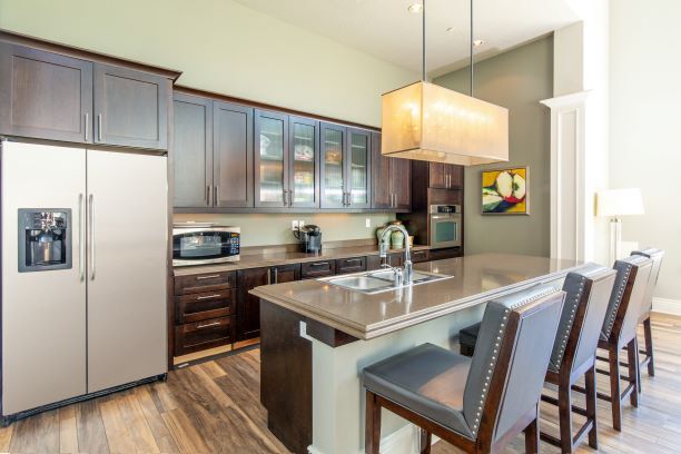 Clubhouse Kitchen with Island - San Tropez Apartments & Townhomes