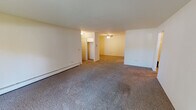 Located at 419 E Circle Hill Drive in Arlington Heights, Illinois, this single-floor unit offers a practical and well-organized layout suited for comfortable everyday living. The interior is finished with neutral-toned walls and wall-to-wall carpeting throughout the main living and sleeping areas, creating a cohesive and understated aesthetic.

The living area is generously sized, with open sightlines that allow the space to feel expansive. A sliding glass door provides direct access to the outdoors and brings in natural light, while baseboard heating ensures year-round comfort. A ceiling fan in the adjoining area adds to the functionality of the space.

The kitchen stands out as a notably upgraded feature, showcasing rich cherry wood cabinetry, dark granite countertops, stainless steel appliances including a refrigerator, electric range, and built-in microwave, and light tile flooring. The layout is efficient and well-appointed.

The bedroom is a comfortable size, featuring a sliding-door closet with ample storage and a window that allows natural light to filter in. The bathroom is cleanly finished with a full tub and shower surround, tile flooring, and a vanity with a granite-topped surface. Baseboard heating is present throughout, and the entry features a dedicated foyer area providing a clear transition into the living space.