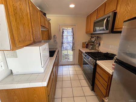 Galley Kitchen, New Stove, Microwave & Refrigerator included. - 1711 Speyer Ln