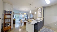 This thoughtfully designed 1-bedroom, 2-bathroom residence spans a single floor and makes efficient use of its space through an open-concept layout. Polished concrete floors flow throughout, giving the home a sleek, contemporary feel.

The kitchen serves as a central hub, featuring granite countertop surfaces, dark cabinetry, a subway tile backsplash, black appliances including a gas range and French door refrigerator, and a peninsula with bar seating illuminated by modern pendant lighting. The kitchen opens seamlessly into the combined dining and living area, which is bathed in natural light from floor-to-ceiling sliding glass doors that lead to a private balcony overlooking lush outdoor greenery.

The bedroom offers a comfortable retreat with a large window framing outdoor views, a ceiling fan, and direct access to a dedicated closet for ample storage. Two full bathrooms serve the residence; one features a elongated vanity with granite counters, dark wood cabinetry, a large mirror, and a tub-shower combination with clean white subway tile surround.

The overall ambiance is modern and cohesive, with neutral tones, warm accent lighting, and stylish finishes that create an inviting and functional living environment.
