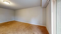 Located at 985 N Broadway in De Pere, Wisconsin, this single-floor, one-bedroom, one-bathroom unit offers a well-organized layout with a living room, kitchen, bedroom, bathroom, and hallway. The living room is a generously sized, carpeted space featuring a sliding glass door that fills the room with natural light and provides a view of the surrounding greenery outside. The kitchen is thoughtfully updated with white shaker-style cabinetry, granite-style countertops, wood-look plank flooring, and black appliances including a refrigerator and dishwasher, offering both style and functionality. A dedicated hallway connects the main areas and provides a smooth flow throughout the unit. The spacious primary bedroom is finished with warm wall-to-wall carpeting, neutral-toned walls, a textured ceiling, and a window that allows for natural light—creating a calm and comfortable retreat. The bathroom is clean and functional, featuring a full tub-shower combination with a white surround, wood-look flooring, and a classic white toilet, all set against neutral gray walls. Throughout the unit, the consistent use of light, neutral tones and wood-look flooring in key areas creates a cohesive and inviting ambiance, making this a practical and comfortable space.