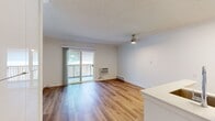 This 330 square foot apartment in Newport Beach offers a compact yet functional living space. The single-floor layout maximizes efficiency, featuring a living room, two bathrooms, and a closet. The living area is characterized by its bright, airy feel, enhanced by a large sliding glass door that provides access to a balcony, allowing natural light to flood the space.

The apartment boasts modern finishes throughout, with sleek wood flooring that adds warmth and continuity to the space. The bathrooms are well-appointed, featuring contemporary fixtures and ample storage. One bathroom includes a spacious vanity with a large mirror and built-in lighting, while the other offers a full-sized bathtub with shower functionality.

The living room serves as the heart of the apartment, with its open design allowing for flexible furniture arrangements. A wall-mounted air conditioning unit provides climate control, ensuring comfort year-round. The closet space is thoughtfully designed, offering built-in shelving and hanging areas to maximize storage in the compact footprint.

Despite its modest size, the apartment's layout and design elements create a sense of spaciousness and modern living, making it an ideal residence for those seeking a contemporary urban lifestyle in the desirable Newport Beach area.