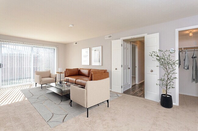 Large living room and dining room with sliding door to balcony or terrace - Village at Mayfield