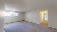 Located at 18562 Royalton Rd in Strongsville, Ohio, this single-floor unit offers a practical and well-organized layout designed for comfortable everyday living. The spacious living area is finished with plush carpeting and features a textured ceiling, multiple HVAC vents for climate control, and a large window with vertical blinds that fills the room with natural light. An adjacent dining area is accented by a classic chandelier and benefits from its own window, contributing to a bright and welcoming atmosphere throughout the shared living space. The galley-style kitchen is efficiently designed with ample upper and lower cabinetry, a stainless steel sink, laminate countertops, a range, and easy-to-maintain hardwood-style vinyl flooring. Multiple bedrooms provide generous floor space, each with plush carpeting, natural light from individual windows, and closets outfitted with built-in rods and shelving for organized storage. The full bathroom includes a tiled tub-and-shower surround, a toilet, and tile flooring, offering a clean and functional space. Throughout the unit, neutral tones and clean lines create a calm, move-in-ready environment suited to a variety of lifestyles.