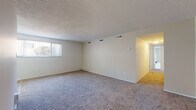 Located at 18562 Royalton Rd in Strongsville, Ohio, this single-floor unit offers a practical and well-organized layout designed for comfortable everyday living. The spacious living area is finished with plush carpeting and features a textured ceiling, multiple HVAC vents for climate control, and a large window with vertical blinds that fills the room with natural light. An adjacent dining area is accented by a classic chandelier and benefits from its own window, contributing to a bright and welcoming atmosphere throughout the shared living space. The galley-style kitchen is efficiently designed with ample upper and lower cabinetry, a stainless steel sink, laminate countertops, a range, and easy-to-maintain hardwood-style vinyl flooring. Multiple bedrooms provide generous floor space, each with plush carpeting, natural light from individual windows, and closets outfitted with built-in rods and shelving for organized storage. The full bathroom includes a tiled tub-and-shower surround, a toilet, and tile flooring, offering a clean and functional space. Throughout the unit, neutral tones and clean lines create a calm, move-in-ready environment suited to a variety of lifestyles.