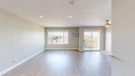 Located at 8501 S Sepulveda Blvd in Los Angeles, CA, this 1-bedroom, 1-bathroom unit offers a clean, modern aesthetic across a well-utilized single floor. Light wood-style flooring flows consistently throughout every room, complementing the neutral gray and beige wall tones that create a bright, cohesive atmosphere.

The open living room is bathed in natural light from a large sliding glass door that leads to a private balcony with neighborhood views, alongside a wide picture window fitted with a wall-mounted air conditioning unit. Recessed lighting enhances the airy feel of the space.

The galley-style kitchen is efficiently designed with white shaker cabinetry, light quartz countertops, and a full suite of stainless steel appliances including a gas range, microwave, and refrigerator. A single-basin sink with a modern faucet lines the opposite wall.

The bedroom is a comfortable, well-proportioned room featuring a sliding mirror closet, a window with outdoor views, and its own wall-mounted AC unit. Recessed lighting keeps the room feeling open.

The bathroom features a dual-sink vanity with white cabinetry and quartz countertops, paired with brushed nickel hardware. A separate water closet contains a full tub and shower combo with clean white tile surround.