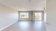 Located at 8501 S Sepulveda Blvd in Los Angeles, CA, this 1-bedroom, 1-bathroom unit offers a clean, modern aesthetic across a well-utilized single floor. Light wood-style flooring flows consistently throughout every room, complementing the neutral gray and beige wall tones that create a bright, cohesive atmosphere.

The open living room is bathed in natural light from a large sliding glass door that leads to a private balcony with neighborhood views, alongside a wide picture window fitted with a wall-mounted air conditioning unit. Recessed lighting enhances the airy feel of the space.

The galley-style kitchen is efficiently designed with white shaker cabinetry, light quartz countertops, and a full suite of stainless steel appliances including a gas range, microwave, and refrigerator. A single-basin sink with a modern faucet lines the opposite wall.

The bedroom is a comfortable, well-proportioned room featuring a sliding mirror closet, a window with outdoor views, and its own wall-mounted AC unit. Recessed lighting keeps the room feeling open.

The bathroom features a dual-sink vanity with white cabinetry and quartz countertops, paired with brushed nickel hardware. A separate water closet contains a full tub and shower combo with clean white tile surround.