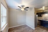 Located at 9200 N MacArthur Blvd in Oklahoma City, Oklahoma, this single-floor, three-bedroom, two-bathroom home offers a practical and well-appointed layout. The living area features durable wood-style flooring in a rich dark tone, neutral beige walls, and a ceiling fan with light fixture, creating a comfortable and inviting atmosphere. Natural light filters in through windows near the front entry, enhancing the open feel of the space.

The kitchen is a standout feature, boasting dark espresso cabinetry, granite-look countertops, a double-basin sink, and a full suite of stainless steel appliances including a refrigerator, dishwasher, electric range, and over-the-range microwave. The wood-style flooring continues seamlessly into this functional cooking space.

All three bedrooms are carpeted and equipped with ceiling fans with light fixtures, providing comfort and airflow. The spacious primary bedroom includes a walk-in closet and a large sliding glass door with vertical blinds offering outdoor access and natural light. The two secondary bedrooms are well-sized with neutral tones throughout.

Both bathrooms are finished with dark vanity cabinetry and granite countertops. One bathroom features a soaking tub and shower combination, while the other offers a standalone walk-in shower, both with brushed nickel fixtures. Two closets provide additional storage throughout the home.
