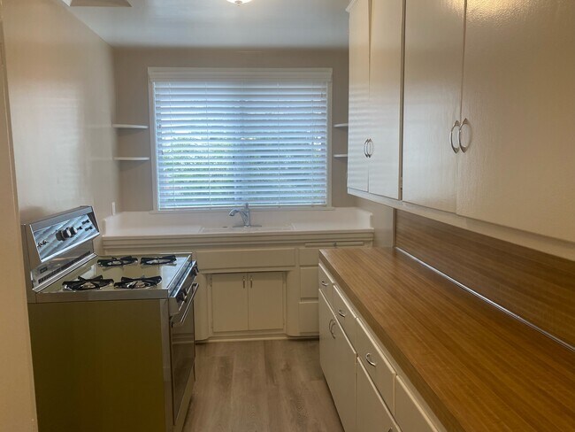 KITCHEN WITH NEW FAUX WOOD BLINDS & GAS STOVE - 3017 W Riverside Dr