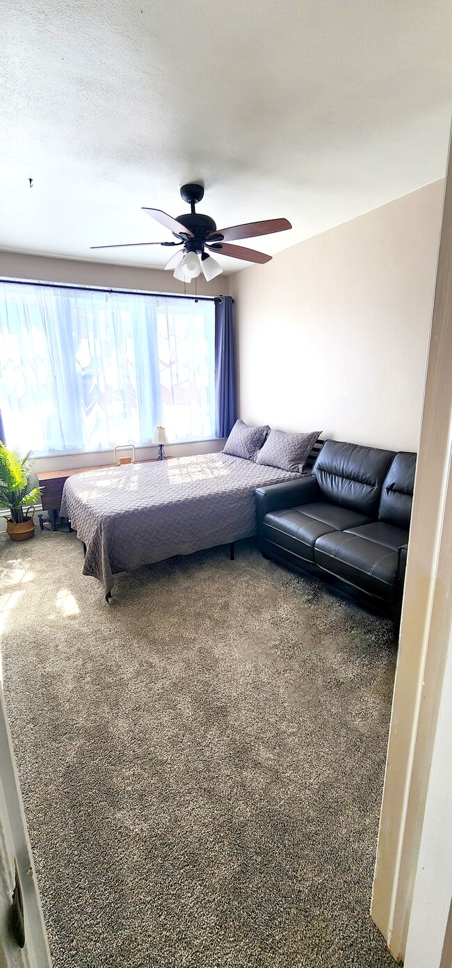 Primary Bedroom with Plush Queen Bed & Loveseat Bright and Inviting with Blackout Curtains - 822 E 4th St