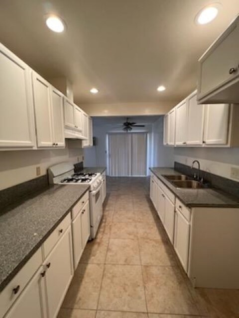 Brand new kitchen with a view of the sliding door that leads to patio - 120 S Sunkist St