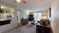 Located at 12205 Valley Lane Dr in Garfield Heights, Ohio, this single-floor residence offers a well-organized layout designed for comfortable everyday living. The living room serves as the heart of the home, featuring plush carpeting, a ceiling fan, and large sliding glass doors that open onto a private balcony, flooding the space with natural light and providing pleasant outdoor views of surrounding greenery. A second seating area adjacent to the balcony offers additional flexibility for relaxing or entertaining. The kitchen is efficiently arranged in an L-shaped configuration, equipped with white cabinetry, a tile-style floor, a full suite of appliances including a range and refrigerator, and a countertop that provides ample workspace. The bedrooms are carpeted and generously sized, each featuring windows that bring in natural light. The primary bedroom includes dedicated closet space and room for substantial furniture arrangements. The residence includes two bathrooms: one features tile walls, a mirrored medicine cabinet, and a shower-tub combination, while the second offers a wide vanity countertop with an integrated sink, a medicine cabinet, and parquet-style flooring. Throughout the home, neutral tones and carpet flooring create a cohesive and understated aesthetic suitable for a variety of personal styles.