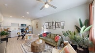 Located at 6755 W McDowell Rd in Phoenix, Arizona, this efficiently designed studio offers a thoughtful single-floor layout that maximizes every square foot. The open-concept living and kitchen area forms the heart of the space, bathed in natural light through a large window dressed with warm rust-toned curtains. A ceiling fan overhead adds comfort, while light wood-style flooring runs throughout, lending a clean, cohesive aesthetic.

The kitchen is outfitted with stainless steel appliances — including a range, over-the-range microwave, refrigerator, and dishwasher — paired with sleek white cabinetry and a marble-look countertop that adds a contemporary touch. The layout keeps the kitchen seamlessly connected to the living area, making the space feel open and functional.

The living area offers enough room for comfortable seating and entertainment, with a large window providing views to the outdoors and a ceiling fan contributing to the airy feel. Neutral, soft-toned walls create a versatile backdrop throughout.

The full bathroom features a tub-shower combination with white tile surround, a marble-look vanity countertop, white cabinetry, and matching light wood-style flooring. Two closets provide practical storage, rounding out this well-appointed Phoenix studio.