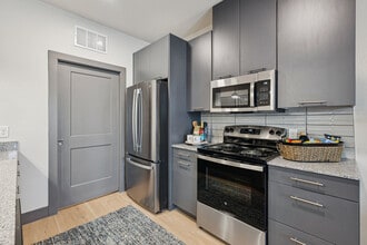 Kitchen with Gray Cabinets and Stainless Steel Appliances - Legacy at Veramendi