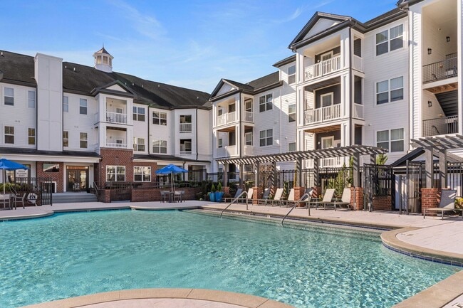 Soak in the sun at our expansive saltwater swimming pool with outdoor TV and cabana - Chancery Village