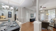 Located at 1919 Post Oak Park Dr in Houston, TX, this well-appointed three-bedroom, two-bathroom residence offers a thoughtfully designed single-floor layout. The open-concept living and dining area is anchored by distinctive decorative columns and warm hardwood flooring, creating an inviting, flowing space filled with natural light from large windows. Crown molding and ceiling fans add refined finishing touches throughout.

The formal dining area accommodates a full-sized dining table beneath an elegant chandelier, while a built-in bookcase and patio access enhance the comfortable living room. The kitchen features white cabinetry with under-cabinet lighting, granite countertops, a tile backsplash, stainless steel appliances, and a convenient breakfast bar.

The spacious primary bedroom offers soaring ceilings and plush carpeting, providing a serene retreat. Additional bedrooms also feature vaulted ceilings and ample closet space. The primary bathroom is outfitted with a dual-sink vanity topped with granite, white cabinetry, and tile flooring, offering both style and functionality.

With two dedicated closets, neutral tones throughout, and quality finishes in every room, this residence delivers a comfortable and polished living experience in one of Houston's desirable neighborhoods.